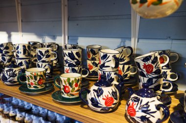 colorful ceramic tableware, kettles in the store.dishes of different colors are in the store.