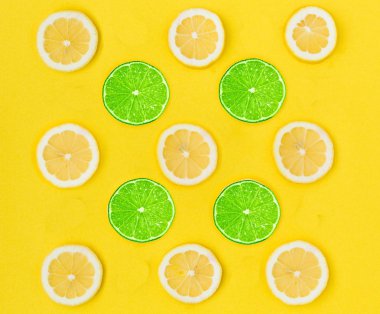 Close up of yellow lemon and green lime on the yellow background, Fresh lemon and lime slice and sour fruit or citrus fruit