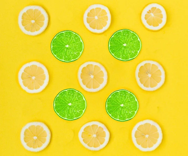 Close up of yellow lemon and green lime on the yellow background, Fresh lemon and lime slice and sour fruit or citrus fruit