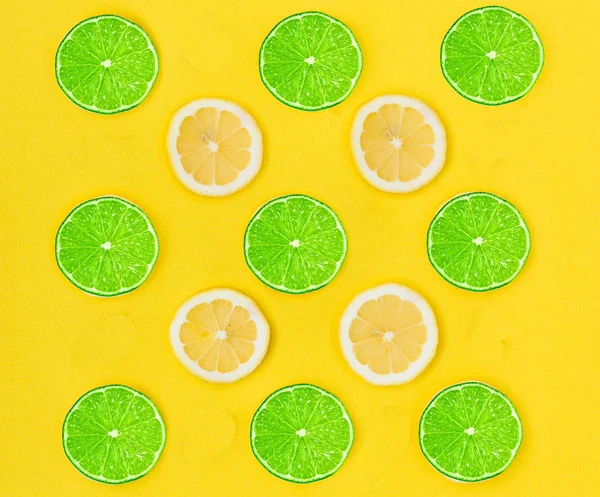 Close up of yellow lemon and green lime on the yellow background, Fresh lemon and lime slice and sour fruit or citrus fruit