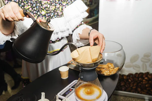 pour over coffee brewing method whole process by barista girl, Coffee drip on the table, Girl barista bartender waiter in uniform making coffee