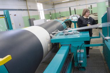 Bakü, Azerbaycan, 20 Şubat: Tekstil endüstrisi için renkli ipek ipliği üretmek için arka planda makine donanımı bulunan yakınlardaki fabrikada çalışan kadın işçiler.