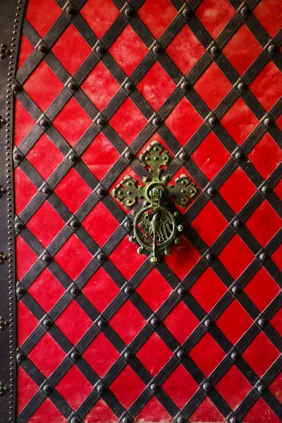 A black forged handle on the red iron door. Old vintage door with iron handle. — 스톡 사진