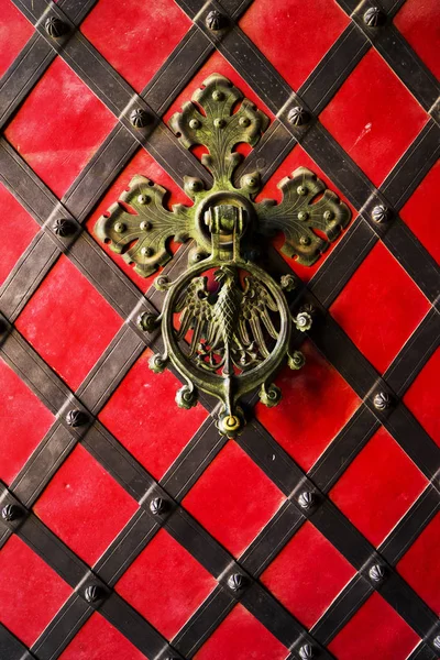 A black forged handle on the red iron door. Old vintage door with iron handle. — 스톡 사진