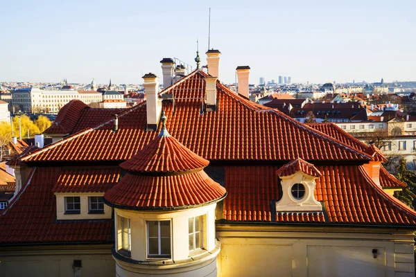 Top view to red roofs skyline of Prague city, Czech Republic. Aerial view of Prague city with terracotta roof tiles, Prague, Czechia. Old Town architecture with terracotta roofs in Prague