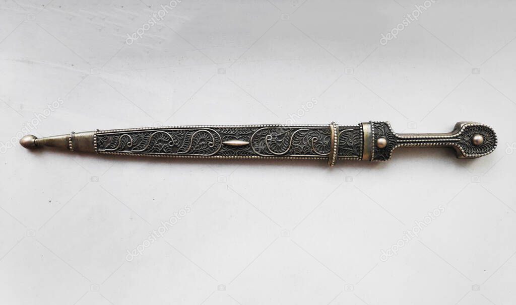 Isolated White Background Antique Dagger, Old dagger with a silver sheath to carry the weapon isolated on a white background with copy space.
