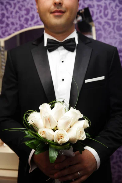 Homem Noivo Terno Preto Prende Buquê Rosas Brancas Suas Mãos — Fotografia de Stock