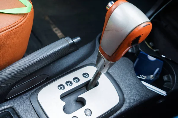 Automatic gear stick with manual selection option.Detail on a automatic gear shifter in a luxury car.