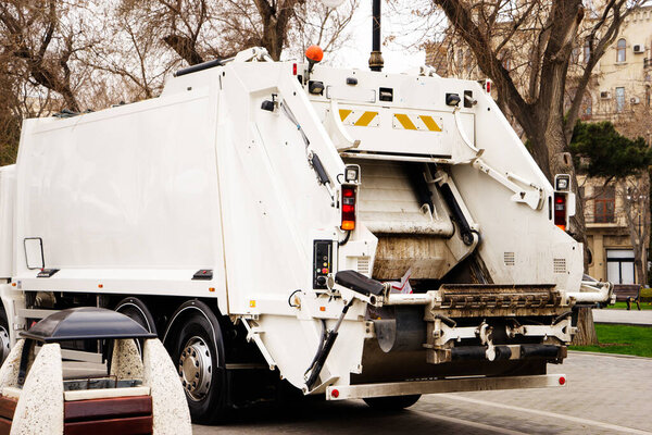 Back of a city garbage truck with waste already inside
