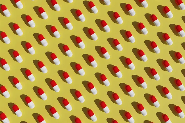 黄色の背景に赤と白の錠剤のパターン 3Dイラスト — ストック写真