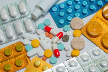 Beyaz arka planda farklı renkte haplara yakın