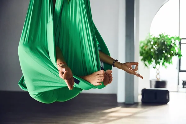 一个成年妇女的内部拍摄练习不同的倒置反重力瑜伽与吊床在瑜伽工作室 精神和身体 一个人的努力和成就概念之间的平衡 — 图库照片