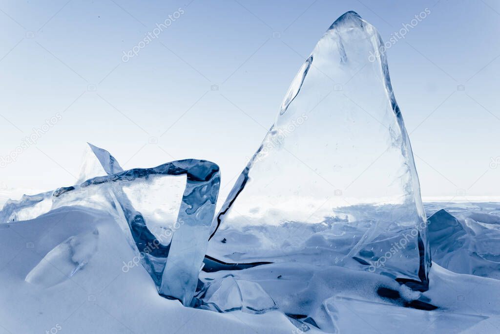 Blocks of ice gleaming in the sun. Arctic winter background. Winter ice along the shore.