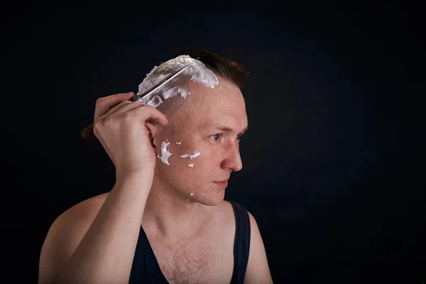 Man doing haircut by himself at home while Covid-19 . Self outbreak lifestyle.