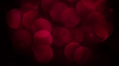 Kırmızı Mutlu Noeller sihirli Bokeh arka planı aydınlatıyor. Cazibeli Sevgililer Günü duvar kâğıdı. Yılbaşı, yıldönümü kutlamaları ve düğün törenleri için gösterişli full HD video..