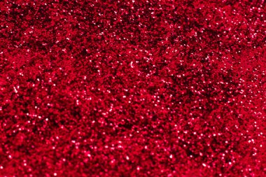 Kırmızı parıltılı doku. Şenlikli ışıl ışıl pullar arka planda yakın plan. Sevgililer günü, yeni yıl ve Noel tatilleri için parlak parlak duvar kağıtları..