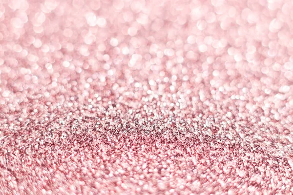 Pink glitter texture. Festive sparkling sequins background closeup. Brilliant shiny walpaper for the day of St. Valentine, New Year and Christmas Holidays.