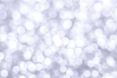 Bokeh ışıkları olan gümüşi ışıltılı bir arka plan. Yeni yıl, Noel tatilleri ve yıldönümleri için kutlama konsepti.