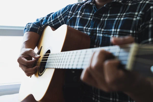 Gitar çalmak mavi kareli gömlek giyen erkekler kadar kapatın