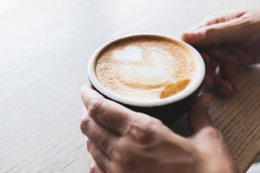 kadın eli sıcak cappuccino kahve kupa tutuyor 