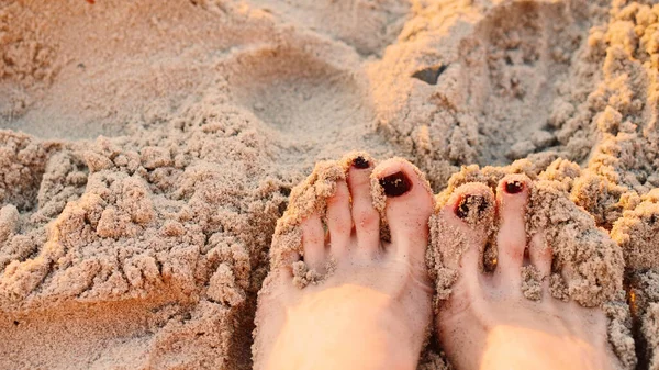 Relax on the beach, feet on the sand. close-up. This is for text.