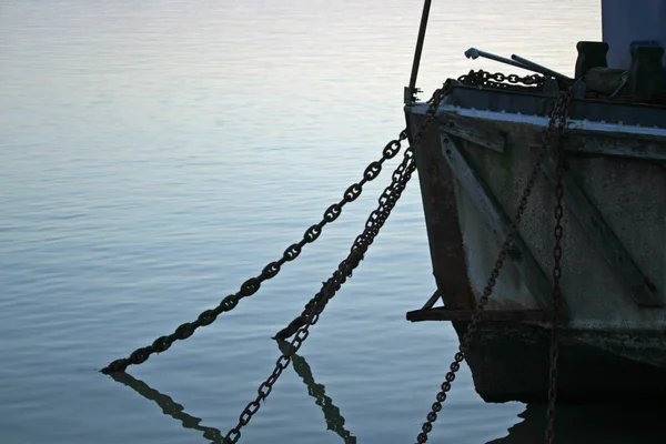 许多锚链挂在河上的船停泊在埃塞克斯蹲在艾塞克斯与反射的水中的锁链 背景仍然是水从河 — 图库照片