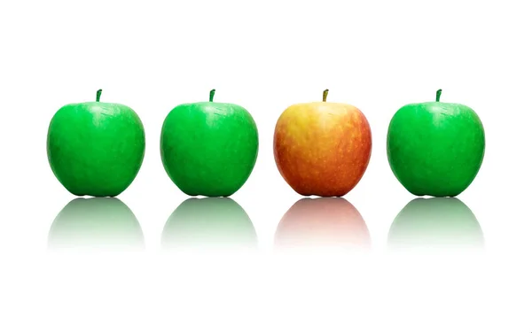Four apples in a row , three being green and one is red wich makes it stand out as a sign of being different