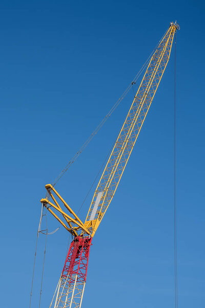 Multiple tower cranes above a concrete structure. 