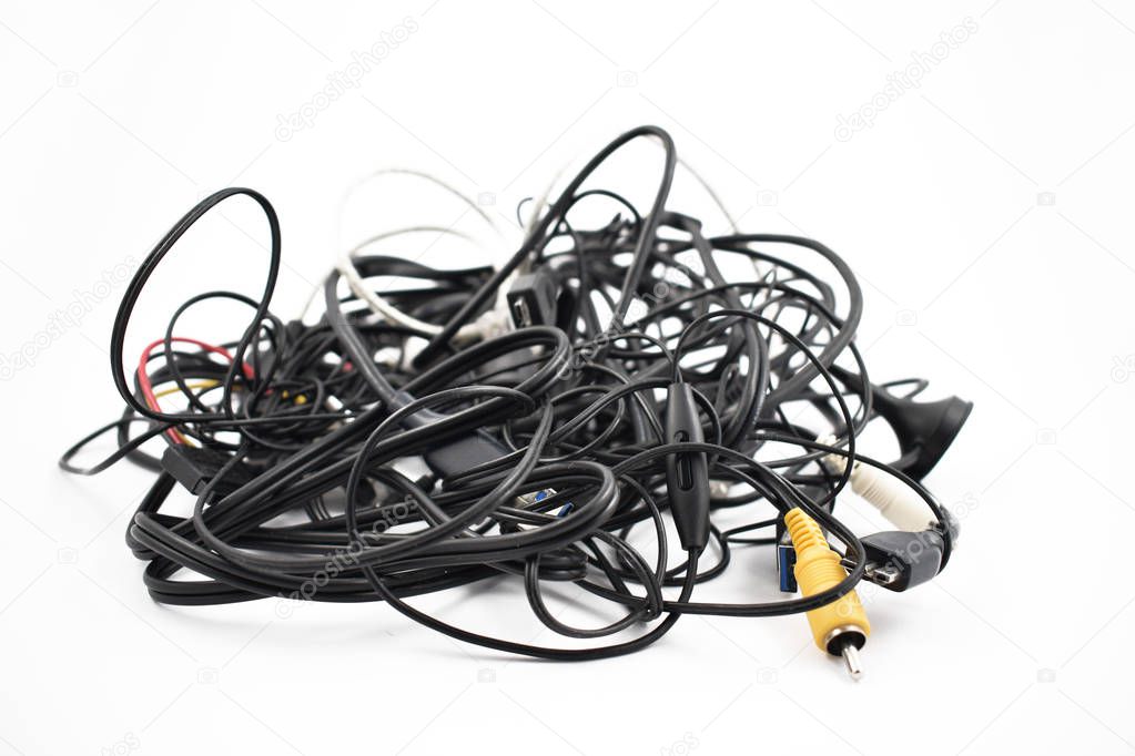 Tangled cables and connectors stock images. Tangle of cables on a white background. Plastic electronic waste. Pile of cables and connectors