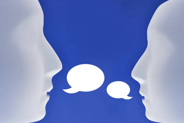 Communication of two heads stock images. Two heads silhouette. Plastic human face stock images. Plastic white face mask stock images. White mask on a blue background. Two plastic human mask