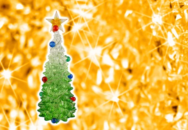 Golden christmas background with a tree stock images. Simple Christmas card. Christmas decoration on a golden background. Christmas tree with a star. Holiday background with copy space for text