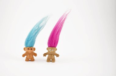 Troll cute vintage toy stock photo images. Elf on a white background. Hairy troll. Troll girl and boy figure. Troll toy images. Two trolls with pink and blue hair isolated on a white background. Couple of trolls