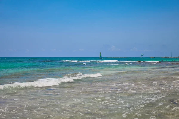 Blick auf tropischen Strand. Touristen fahren Fallschirmboot mit Fallschirm. Segeljacht segelt auf Wellen. türkisfarbenes Wasser der Karibik. Riviera Maya Mexiko — Stockfoto