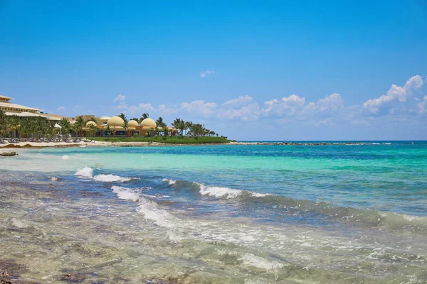 Vista alla spiaggia resort hotel di lusso della costa tropicale. Foglie di palme da cocco svolazzano nel vento contro il cielo blu. Acqua turchese del Mar dei Caraibi. Riviera Maya Messico . — Foto Stock