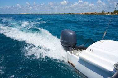 Trail on water surface behind of fast moving motor catamaran in the Caribbean Sea Cancun Mexico. Summer sunny day, blue sky with clouds clipart