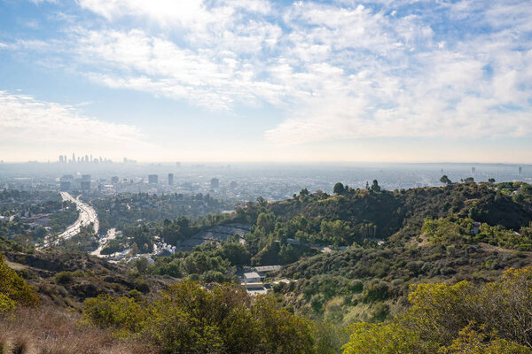 View of Los Angeles from the Hollywood Hills. Down Town LA. Hollywood Bowl. Warm sunny day. Beautiful clouds in blue sky. 101 freeway traffic