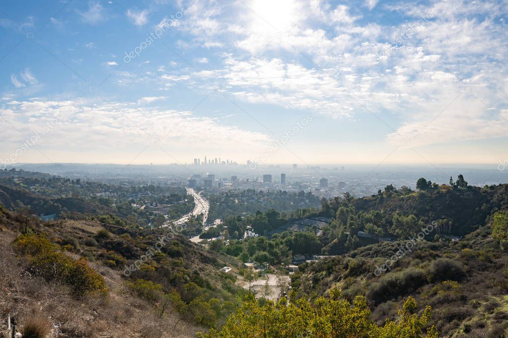 View of Los Angeles from the Hollywood Hills. Down Town LA. Hollywood Bowl. Warm sunny day. Beautiful clouds in blue sky. 101 freeway traffic