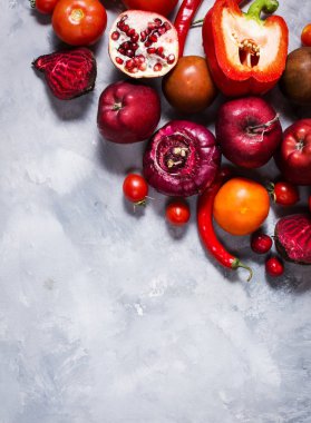 Beton zemin üzerine, üstten görünüm sağlıklı yemek için taze malzemelerle çiğ kırmızı organik sebze. Vegan veya diyet gıda kavramı. Kopya alanı