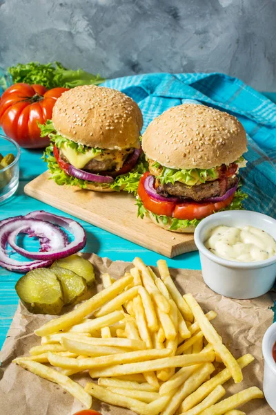 Wołowiny Dwa Hamburgery Frytki Ziemniaki Ogórek Niebieski Stół Drewna — Zdjęcie stockowe