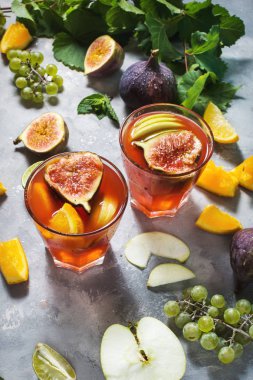 Kokteyl meyve sangria ile elma, portakal, incir, üzüm, nane beton masaya