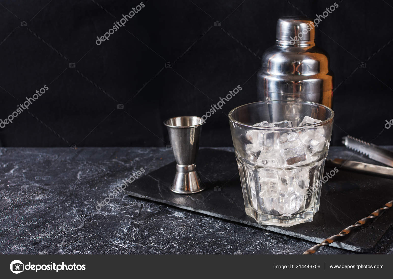 Bar tools for making cocktail. Shaker a of ice on dark stone table. Stock Photo by ©voloshin311