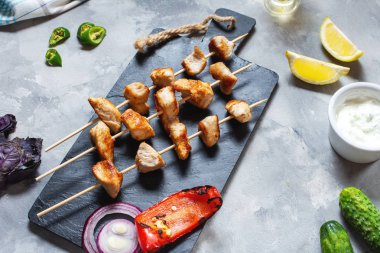 Beton arka plan üzerinde bambu şişler üzerinde ızgara tavuk