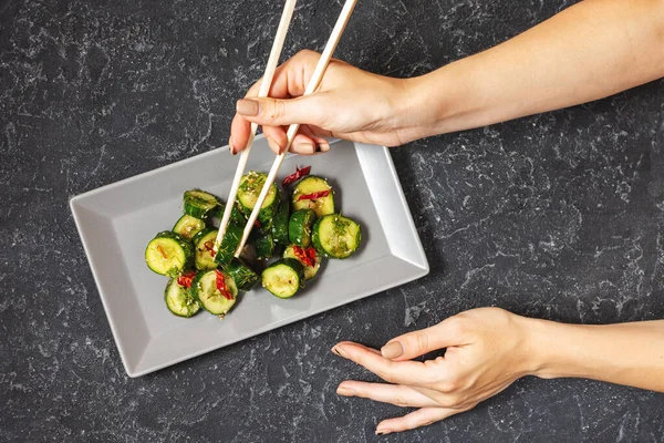 Female Hands Hold Chopsticks Asian Beaten Cucumber Salad Chili Sesame — Stock Photo, Image