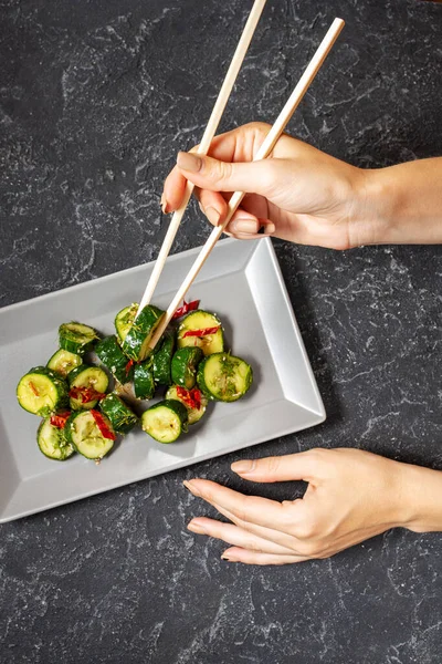 Female Hands Hold Chopsticks Asian Beaten Cucumber Salad Chili Sesame — Stock Photo, Image
