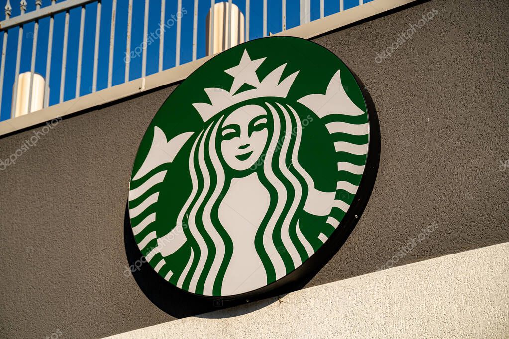 Starbucks Coffee Shop logo sign on building exterior. Windsor, Canada - September 11, 2025.