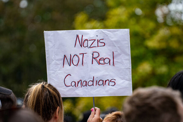 View of Nazis Not Real Canadians banner at pro-immigrant rally.