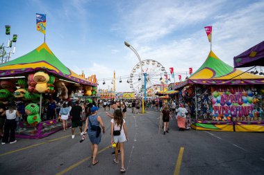 Kanada Ulusal Sergisi CNE 'de kalabalık ve doldurulmuş oyuncak ödülleriyle karnaval oyun standı manzarası. Toronto, Kanada - 16 Ağustos 2025.