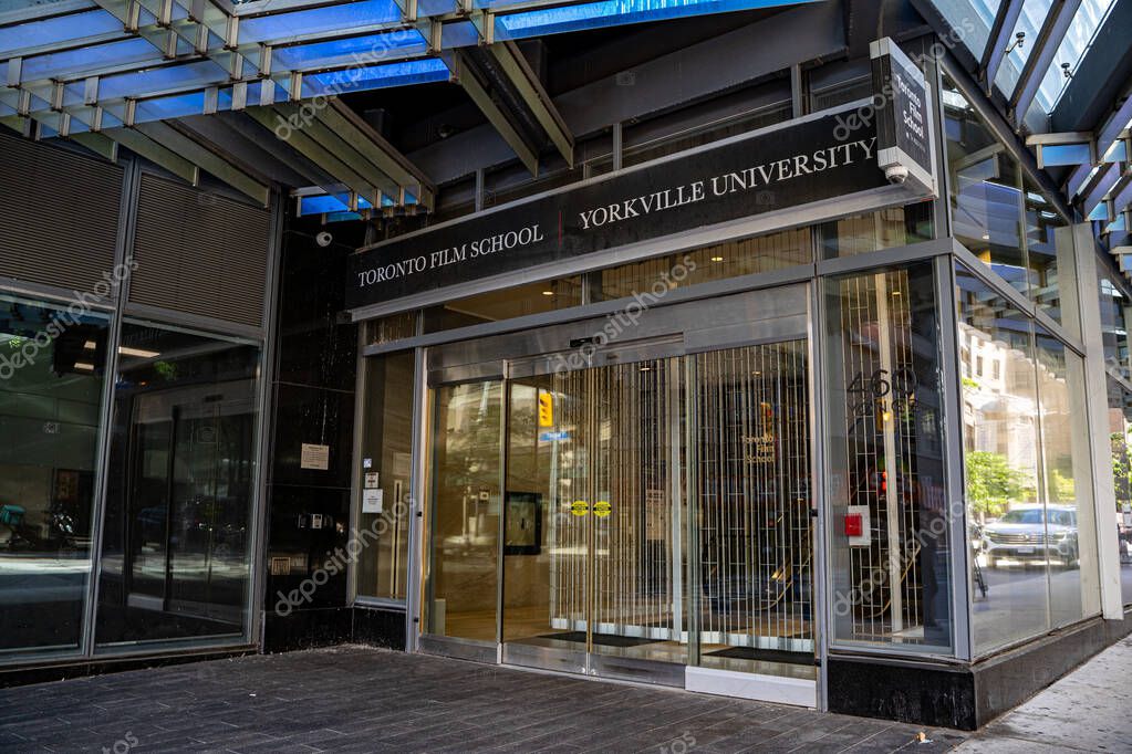 View of Toronto Film School and Yorkville University entrance with glass facade. Toronto, Canada - September 20, 2025.