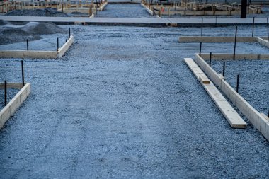 View of gravel construction foundation with wooden framing.