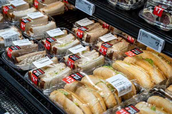 Packaged ready-to-eat sandwiches displayed in refrigerated section of grocery store. Toronto, Canada - September 20, 2025.